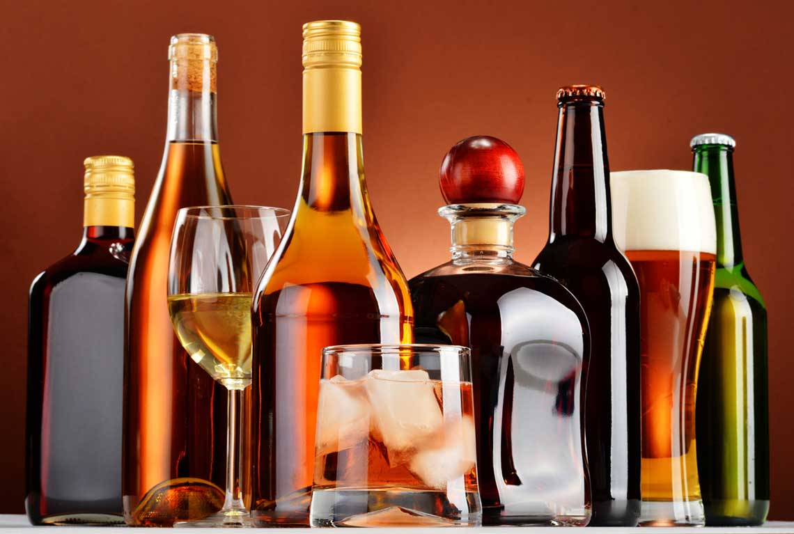 An array of glasses containing liquor, wine and beer
